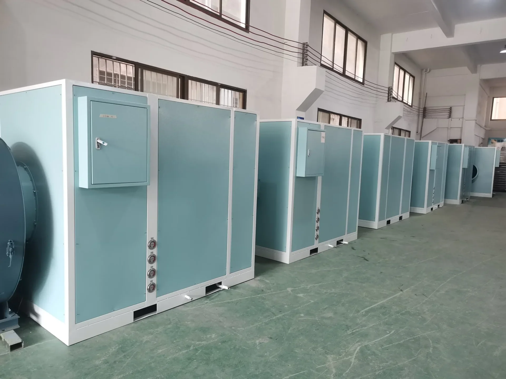 Row of finished heat pump drying units on the assembly floor