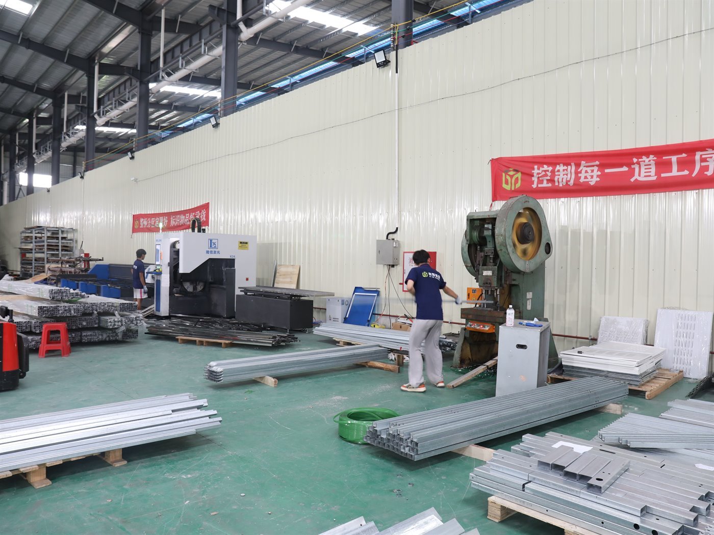 Mechanical press forming steel profiles alongside a CNC fabrication centre on the Guangdong Diye shop floor