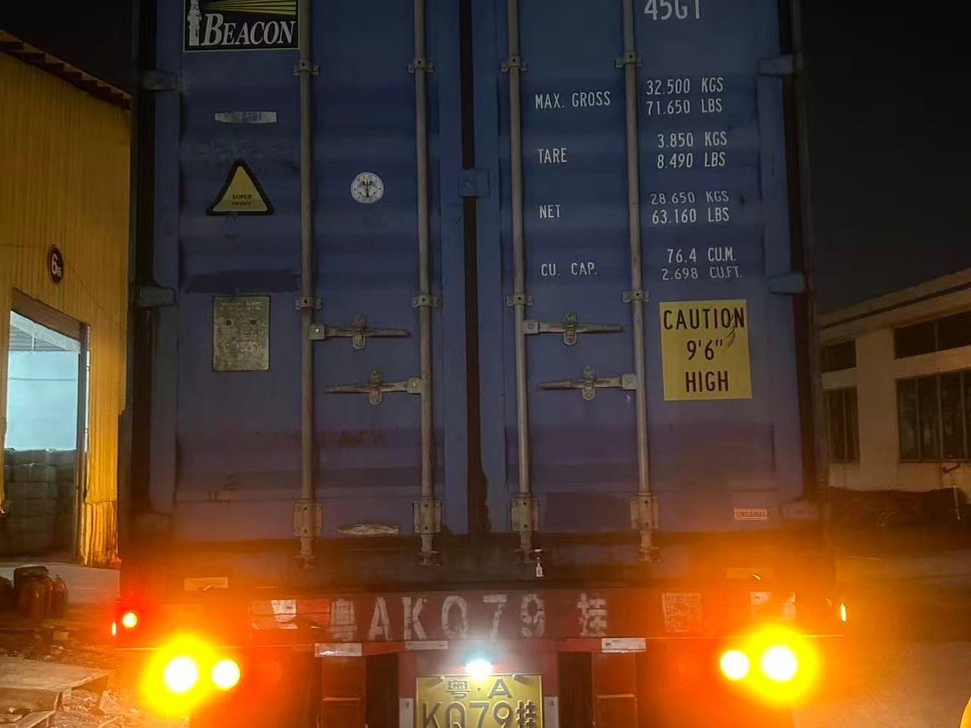 Container doors closed and barred on the loaded trailer at the factory gate